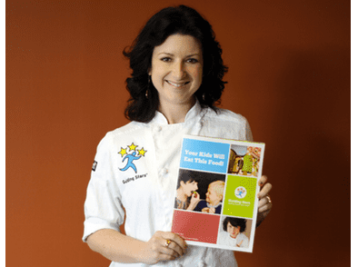 Expert Chef Erin Dow holding recipe booklet