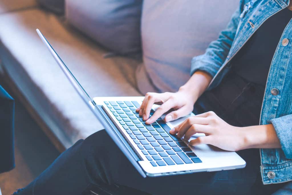 Woman hand works in a laptop computer in the office.