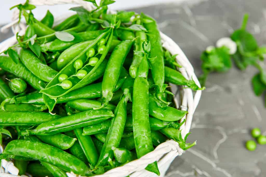 Fresh peas in a white basket