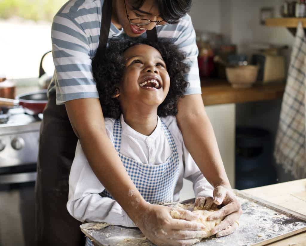 Mother and son kneading dough