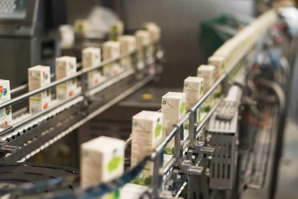 Juice boxes on a conveyor belt.