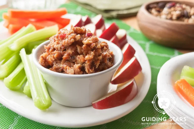 peanut butter dip dish on a plate with vegetables